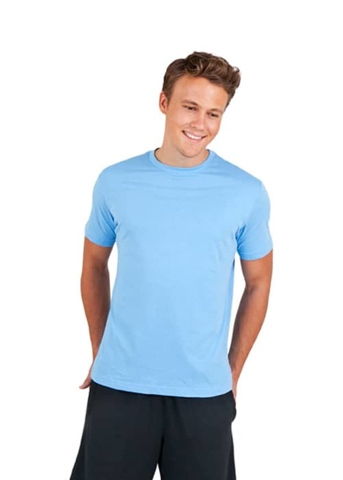A blue men's/unisex American style t-shirt displayed on a smiling model with hands in pockets.