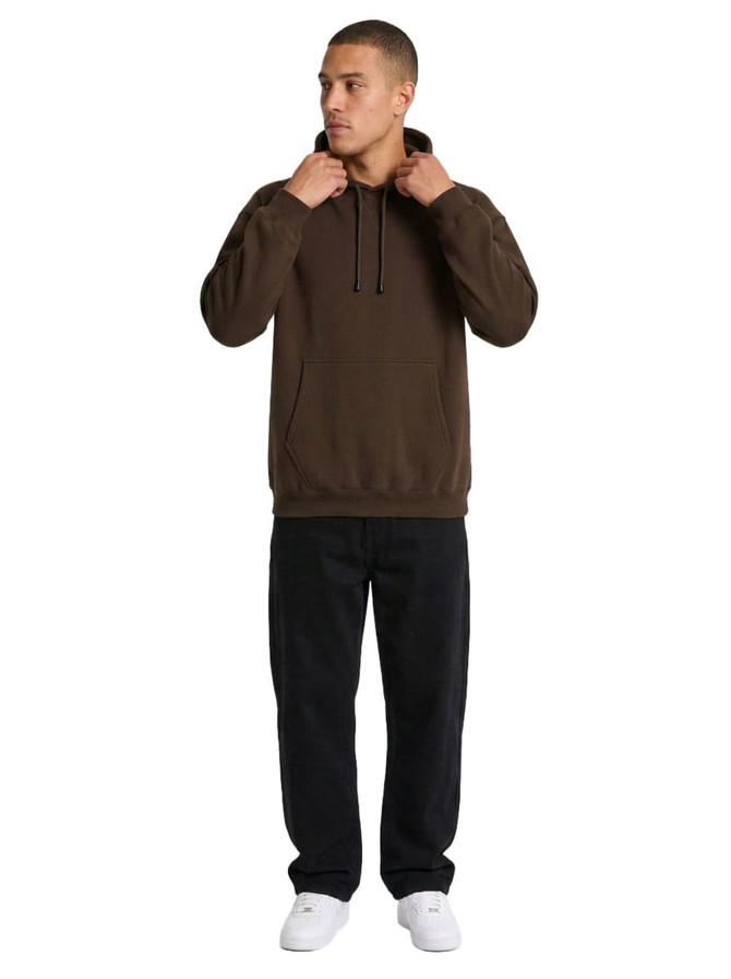 A brown men's kangaroo pocket hoodie is worn by a model, paired with black pants and white shoes.