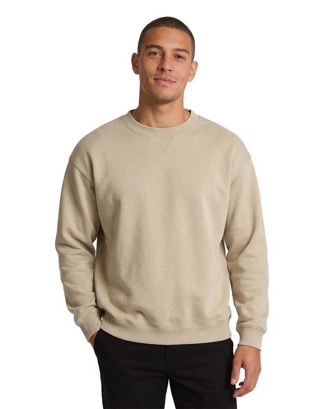 A grey poly cotton fleece jumper worn by a person, paired with a black beanie, featuring long sleeves.