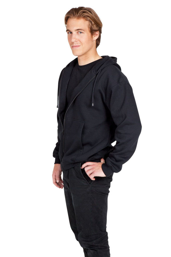 A black zip hoodie with a pocket, worn by a man standing sideways, showcasing the garment's relaxed fit.