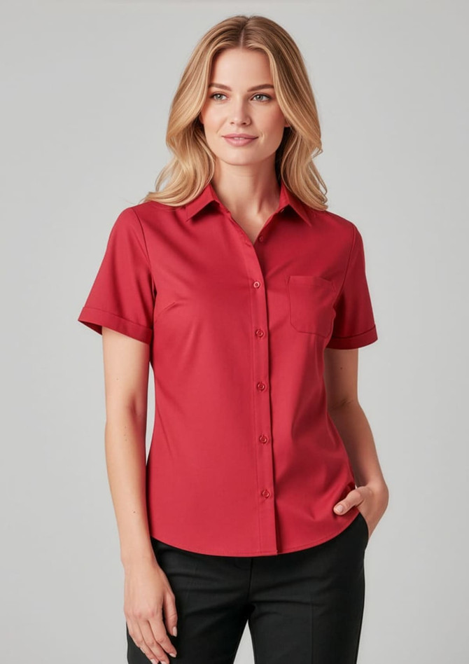 A red short sleeve shirt with a collar and a pocket, featuring a logo.