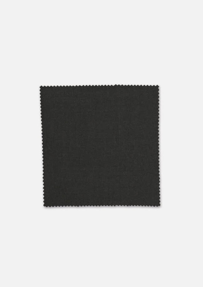 A square swatch of dark grey fabric with a textured finish, featuring a zigzag edge. It has a logo in the corner.
