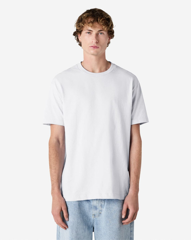 A lightweight unisex t-shirt in white, featuring a round neck and short sleeves, displayed on a model.