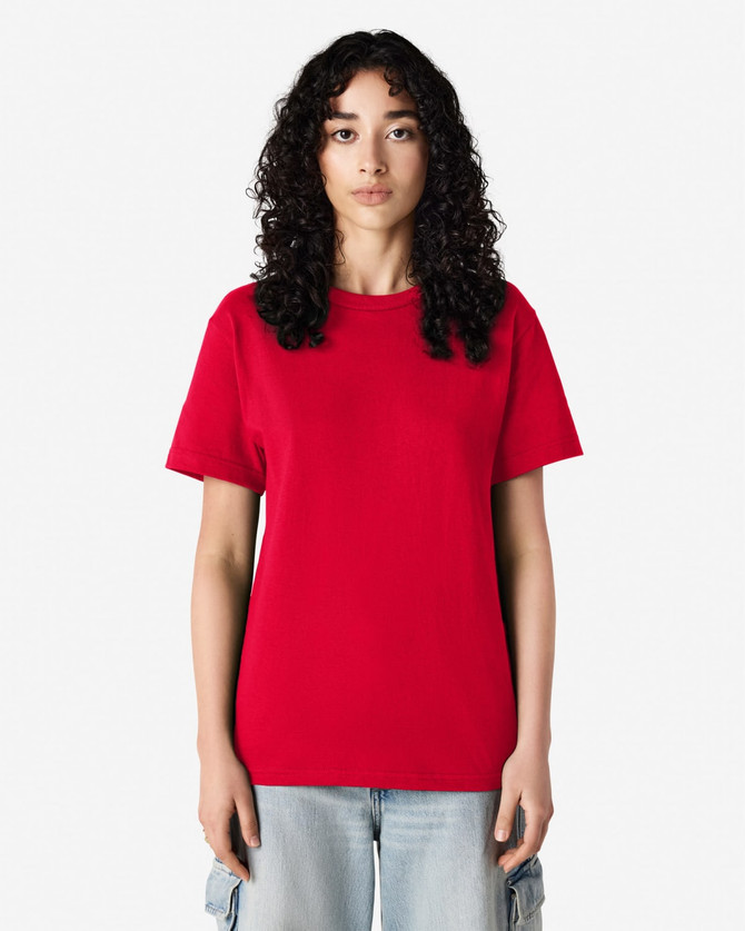 A red heavyweight cotton unisex t-shirt displayed on a model with curly hair, featuring a simple design.