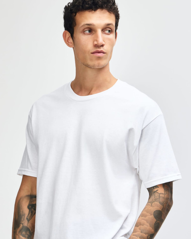 A heavyweight unisex t-shirt in light grey, featuring a classic crew neckline and short sleeves. It has a logo on it.