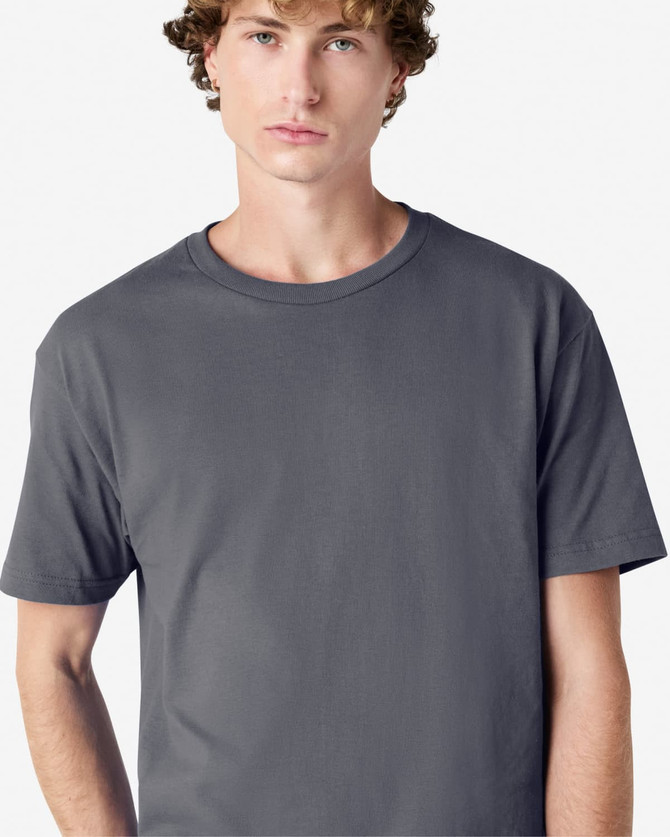 A heavyweight cotton unisex T-shirt in dark grey, featuring a round neckline and short sleeves. It has a logo.