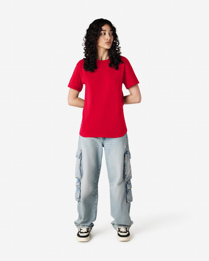 A red heavyweight cotton unisex T-shirt displayed on a model, paired with blue cargo pants.