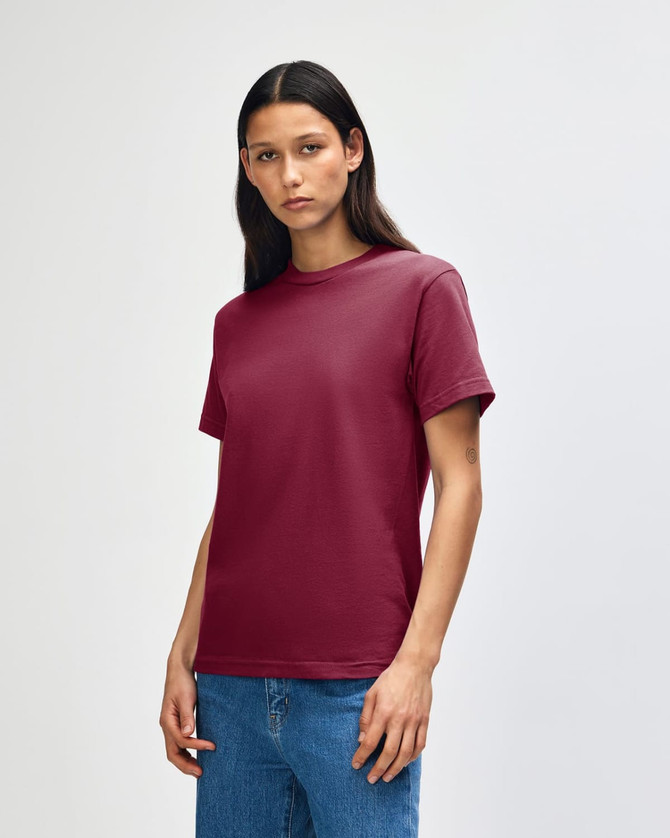 A maroon heavyweight cotton unisex T-shirt displayed on a model, featuring a logo on the collar.