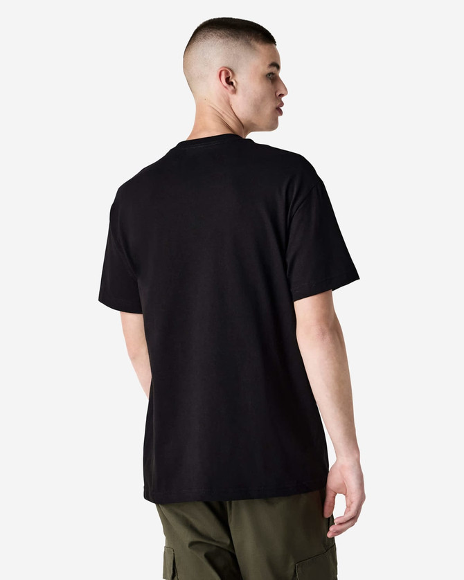A black heavyweight cotton unisex T-shirt displayed on a model from the back, featuring a simple design and loose fit.