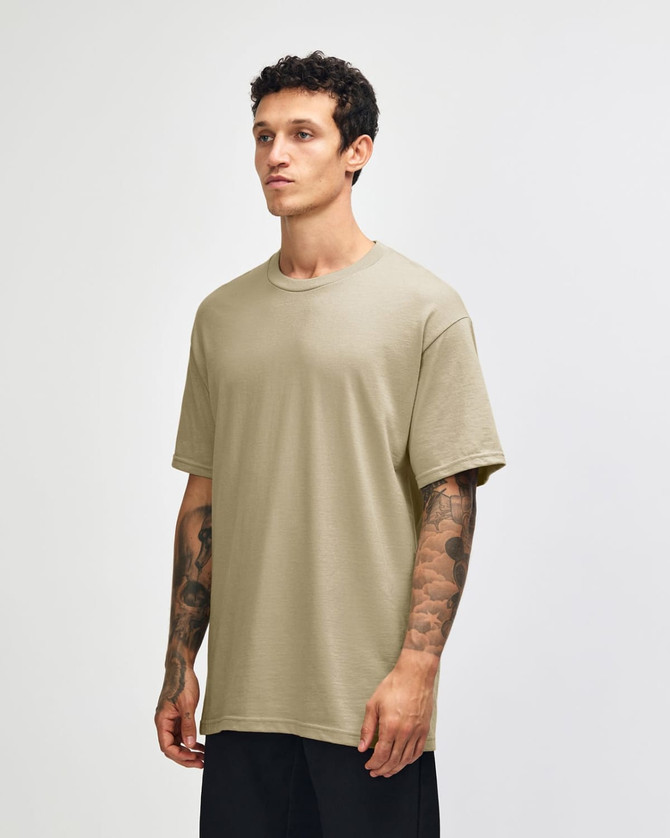 A heavyweight cotton unisex t-shirt in a light beige colour, featuring a crew neck and short sleeves.