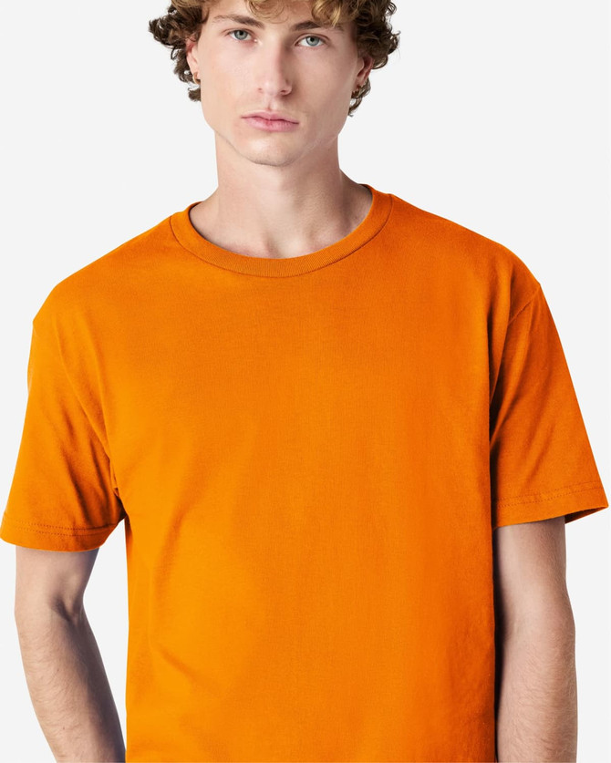 An orange heavyweight cotton unisex T-shirt displayed on a model with a neutral background.