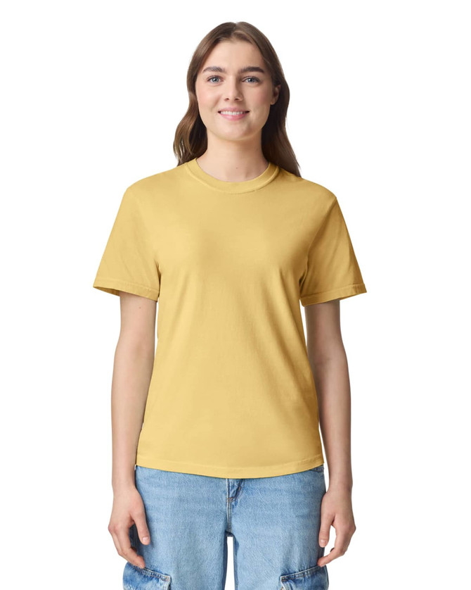 A yellow adult heavyweight t-shirt featuring a round neckline and short sleeves, displayed on a model.