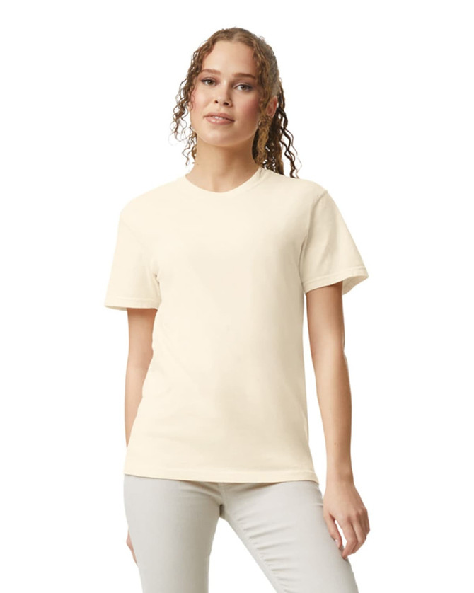 A lightweight heavyweight cream adult t-shirt with a round neckline and short sleeves. The model has a casual pose.