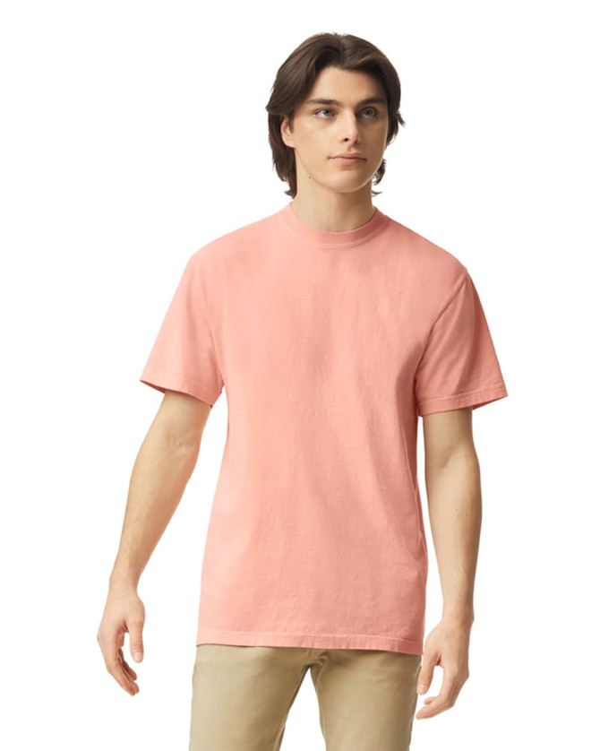 A short-sleeved, coral heavyweight T-shirt on a model, featuring a classic round neckline and no visible logos.
