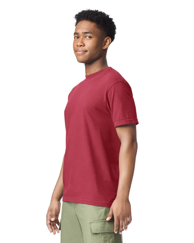 A red heavyweight t-shirt displayed on a model, featuring short sleeves and a crew neck. The model has a neutral expression.