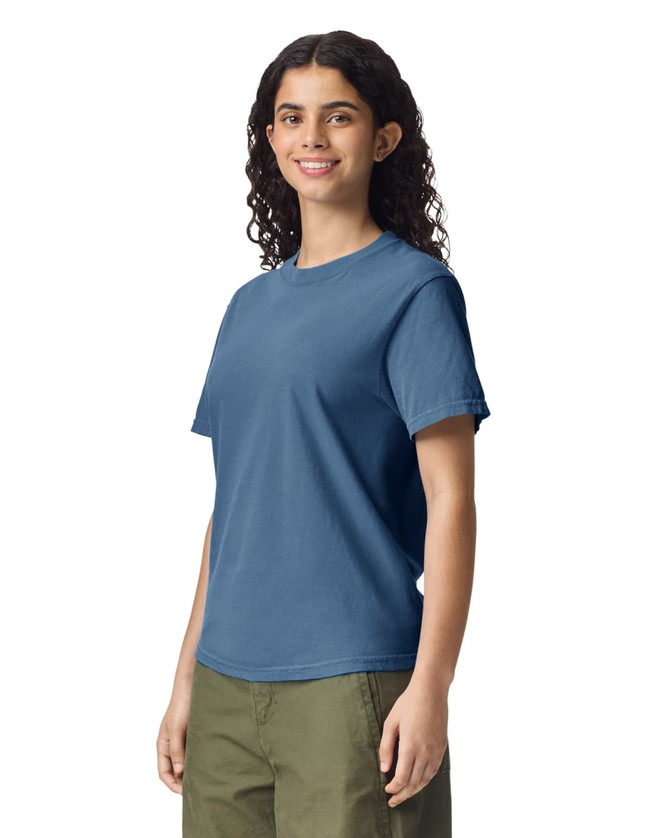 A blue adult heavyweight T-shirt displayed on a model, featuring a simple design and casual fit.