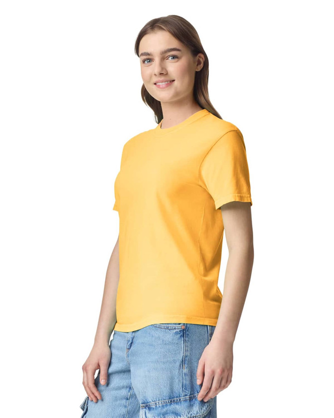A yellow Adult Heavyweight T-Shirt displayed on a model wearing casual shorts, featuring a logo.