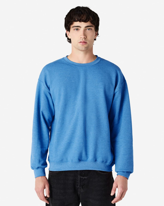 A blue Gildan Heavy Blend adult crewneck sweatshirt displayed on a model. The sweatshirt features a simple design and has a logo.