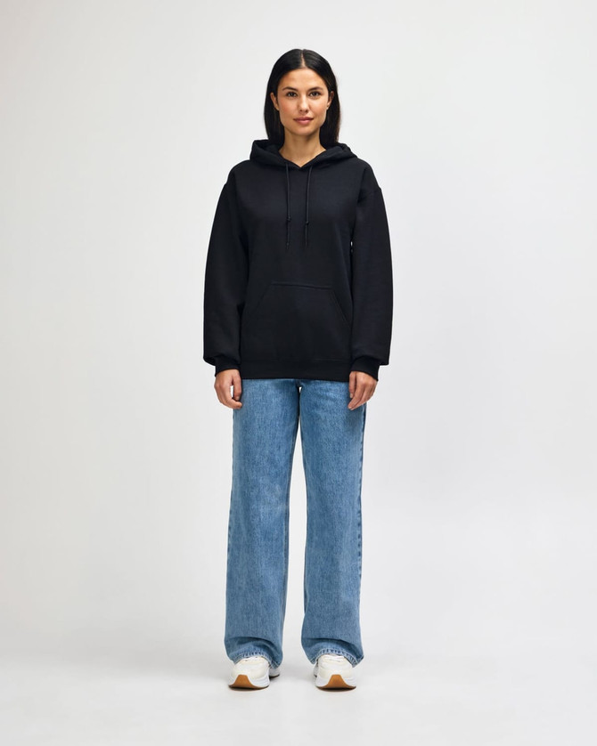 A dark grey hooded sweatshirt worn by a model with jeans and sneakers, featuring a logo on the front.