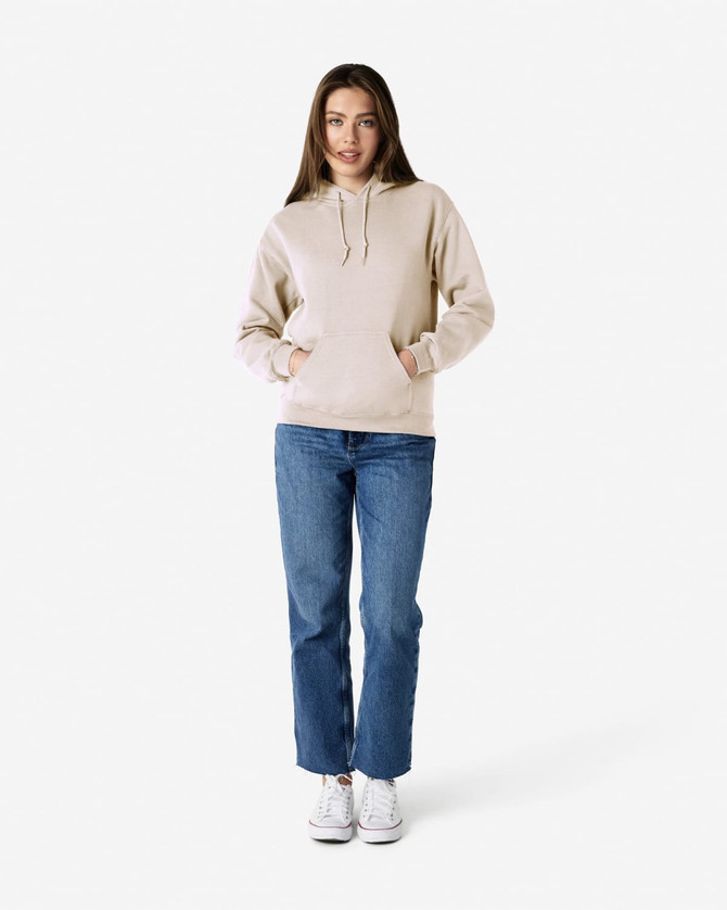 A light beige hooded sweatshirt worn with blue jeans, featuring a front pocket and a drawstring hood.