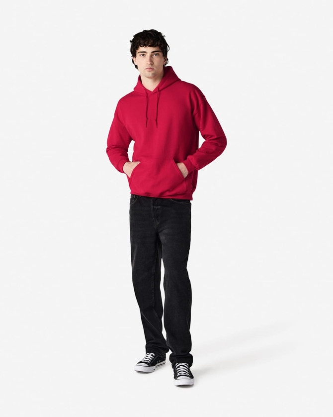 A red hooded sweatshirt with a front pocket, worn by a person in black jeans and sneakers. The sweatshirt features a logo.