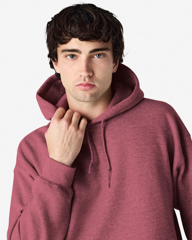A maroon hooded sweatshirt is worn by a model with a hood pulled back, featuring a subtle brand logo.