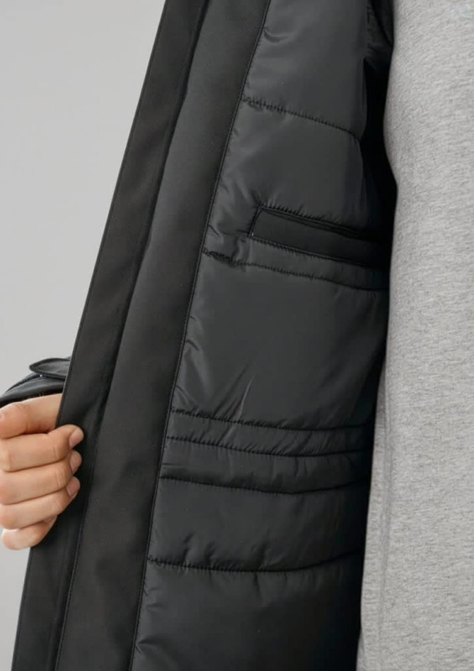 A black unisex rain jacket with a padded interior and inner pockets, showcasing its detailed lining.