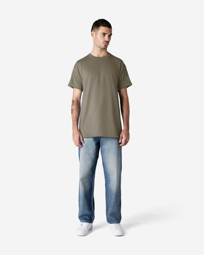 A model stands wearing a plain olive green Gildan Ultra Cotton adult T-shirt paired with light blue jeans.