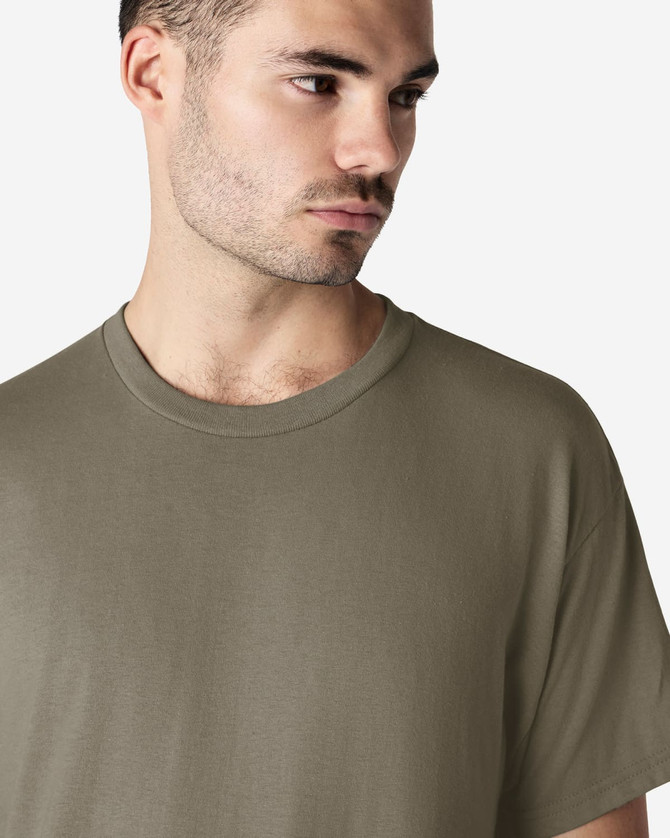 A model wearing a khaki Gildan Ultra Cotton adult t-shirt, featuring a round neckline and short sleeves.