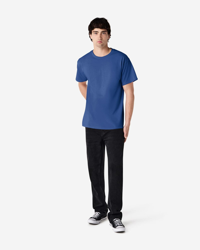 A blue Gildan Ultra Cotton adult T-shirt displayed on a model, paired with black trousers and shoes.