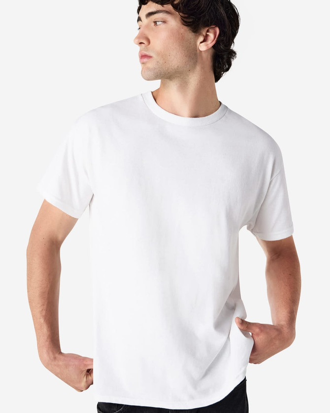 A white Gildan Ultra Cotton adult t-shirt on a model, featuring a simple design and a logo.