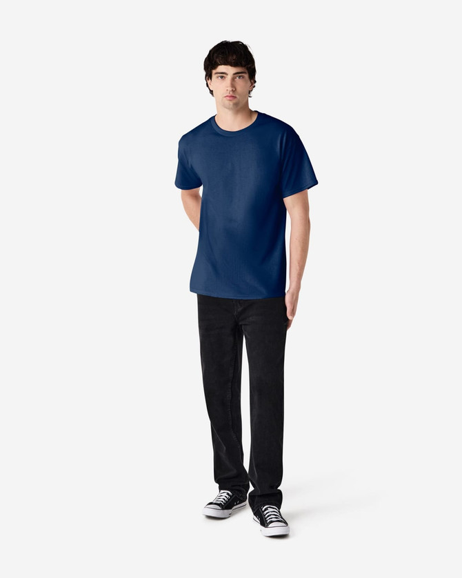 A navy Gildan Ultra Cotton adult t-shirt displayed on a model, paired with black trousers and sneakers.