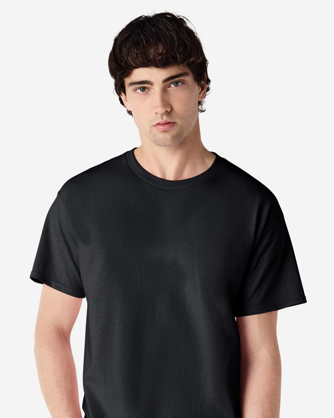 A black Gildan Ultra Cotton adult T-shirt displayed on a male model. The T-shirt has a plain design and logo.
