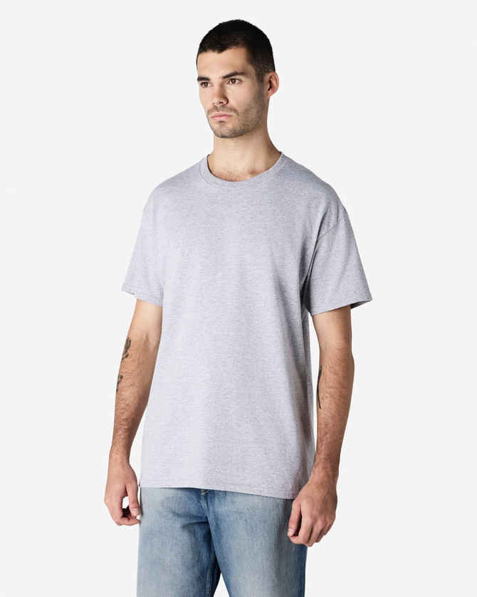 A grey Gildan Ultra Cotton adult T-shirt displayed on a model, featuring a basic crew neck and short sleeves.