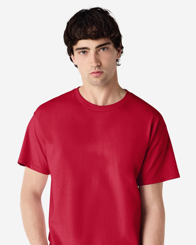 A red Gildan Ultra Cotton adult T-shirt, featuring a crew neck and short sleeves, worn by a model.