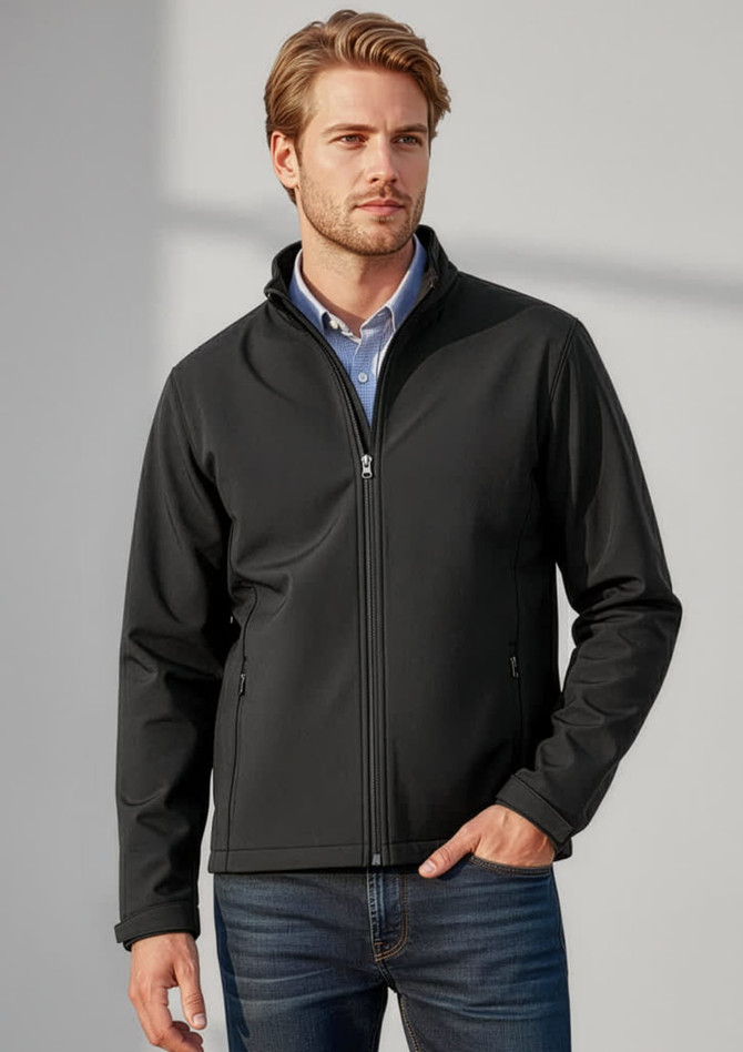 A man wearing a black soft shell jacket, standing against a neutral background, featuring a logo on the jacket.