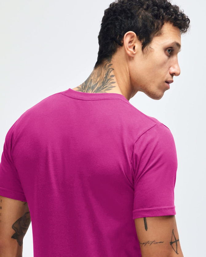 A pink short sleeve T-shirt featuring a simple design and a small logo on the back.