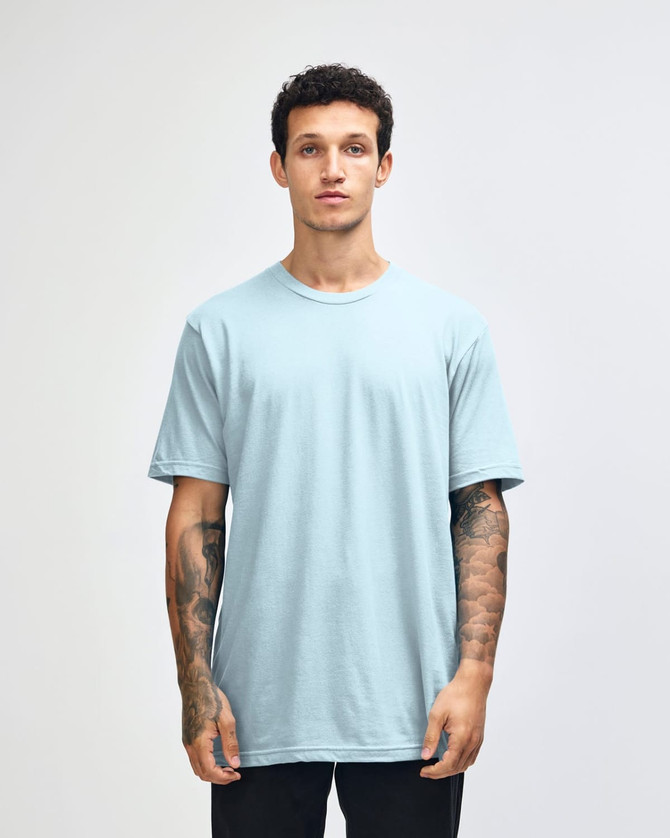 A light blue unisex short sleeve t-shirt displayed on a model. The shirt has a logo branding.