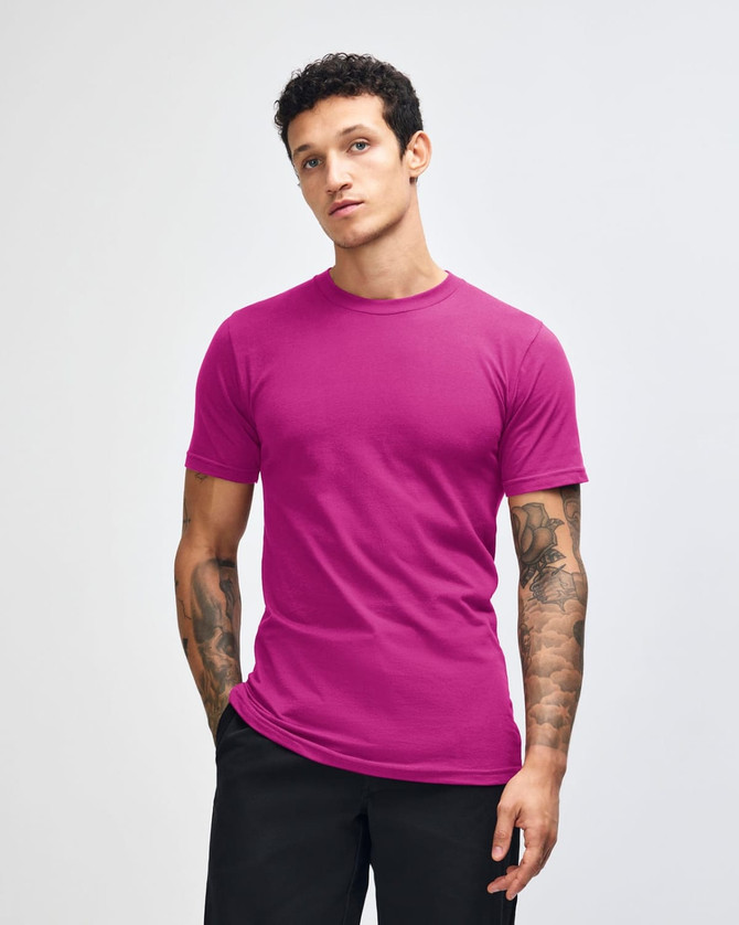 A unisex fine jersey short sleeve t-shirt in a vibrant purple colour, displayed on a model. It features a branding logo.