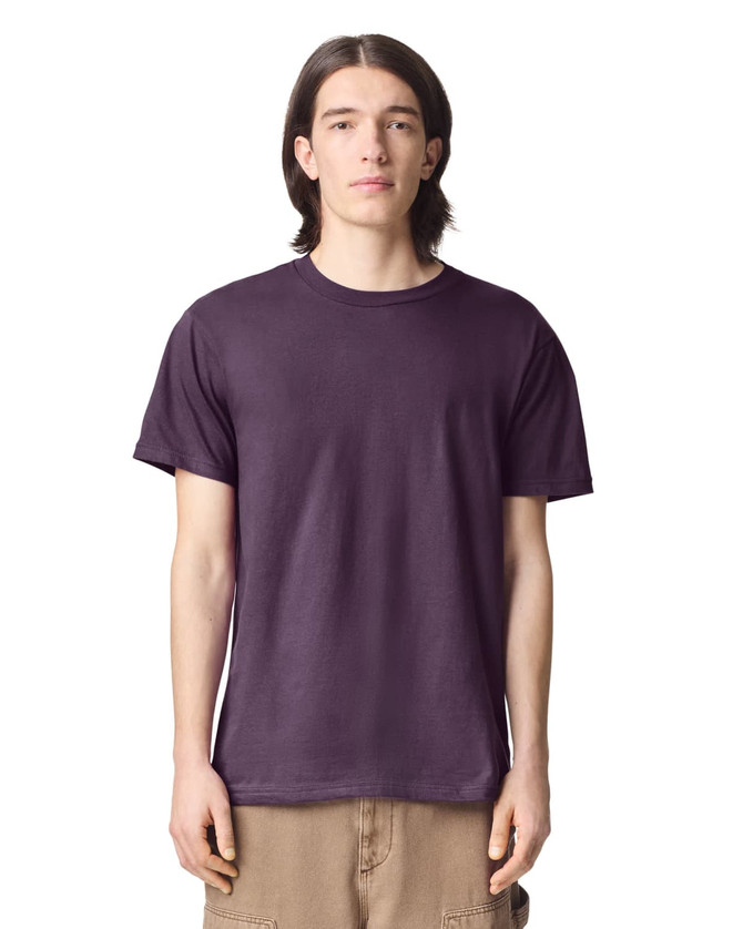 A purple unisex short sleeve t-shirt displayed on a model with straight, long hair. The shirt has a logo.