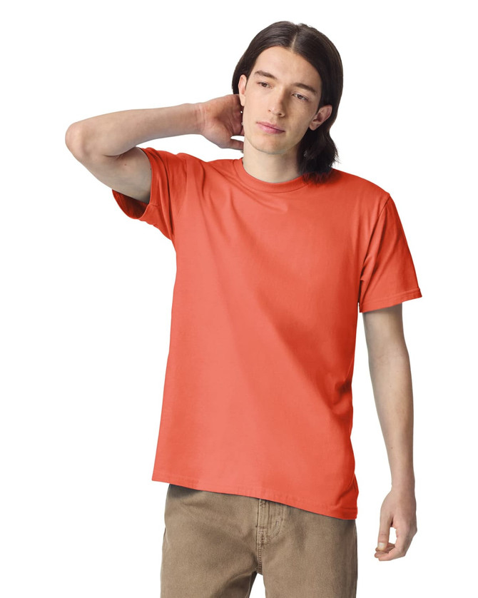 An orange unisex short sleeve t-shirt displayed on a model with long hair, featuring a logo.