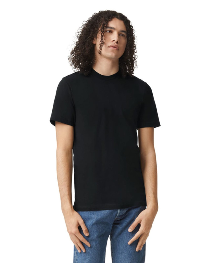 A black unisex fine jersey short sleeve t-shirt displayed on a model, featuring a simple design and relaxed fit.