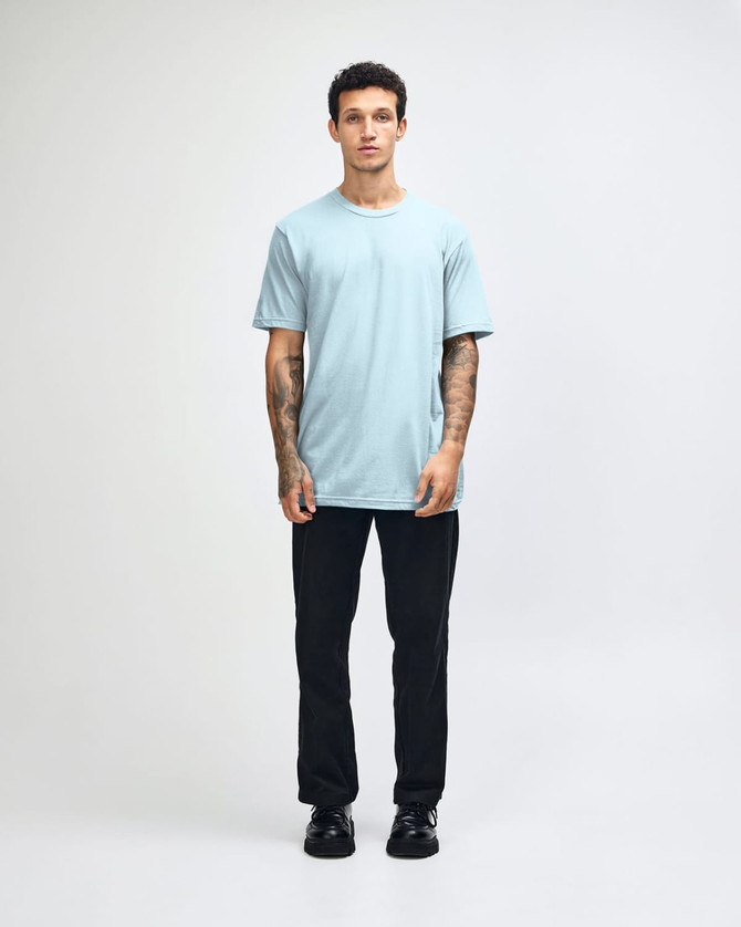 A light blue unisex short sleeve T-shirt with a crew neck and a simple design, featuring a logo.