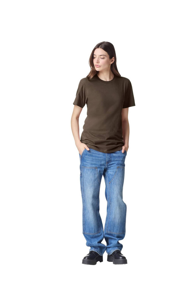 A unisex fine jersey short sleeve T-shirt in olive green, worn with light blue jeans. The model stands casually with hands in pockets.