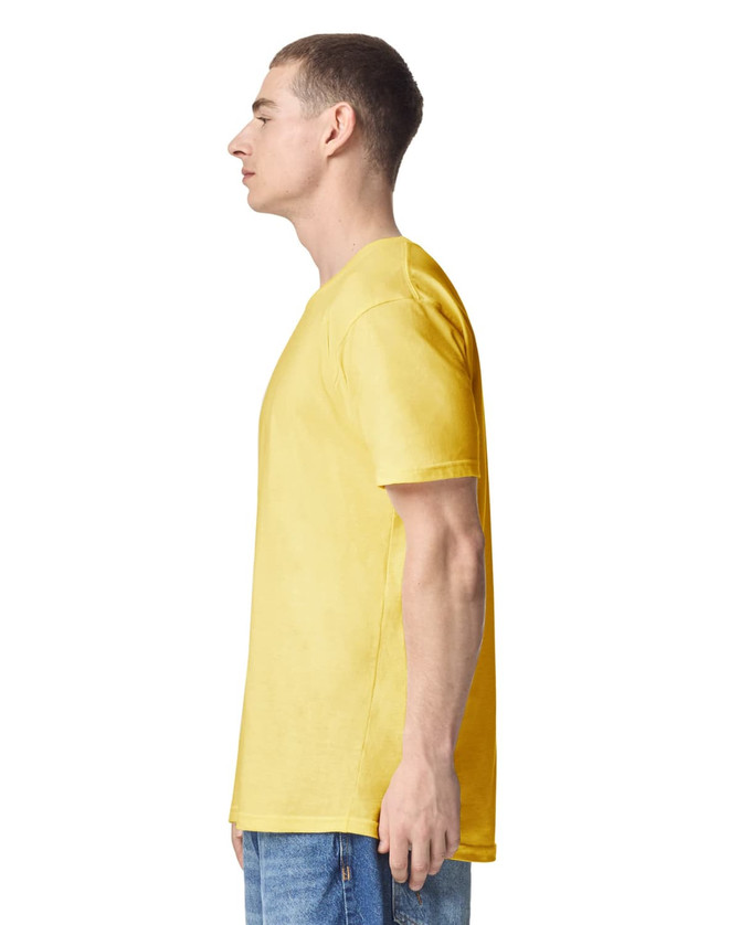 A yellow unisex short sleeve t-shirt displayed on a model from the side, featuring a simple design and a logo.