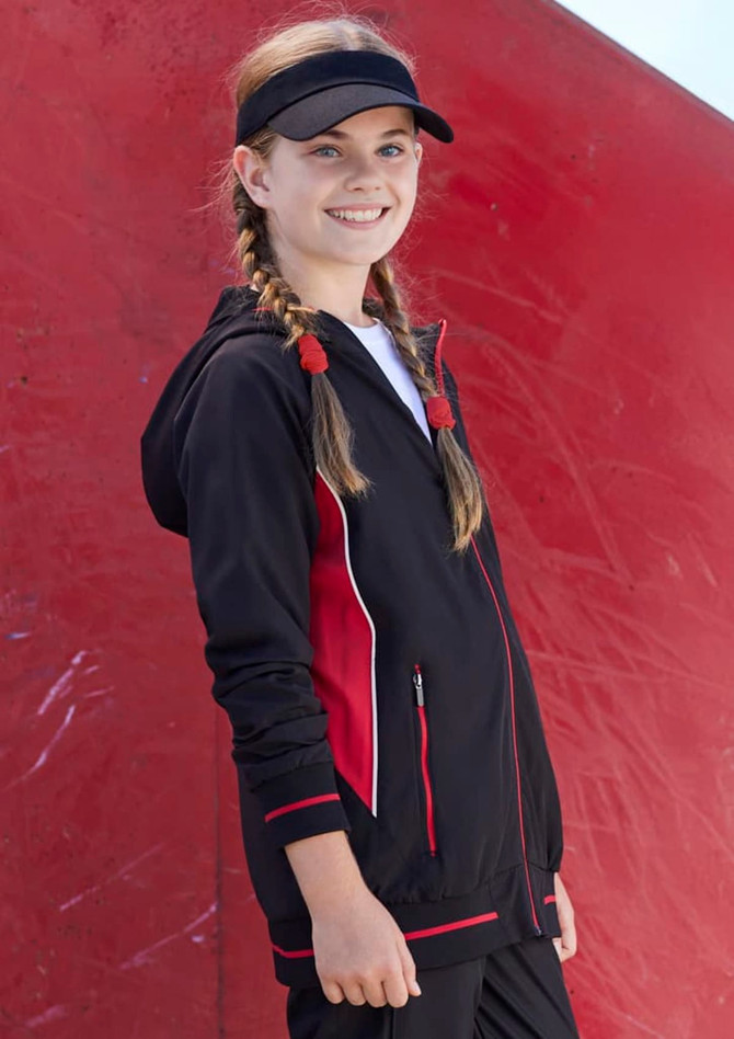 A black and red soft shell jacket worn by a young girl, featuring a hood and zippered pockets.