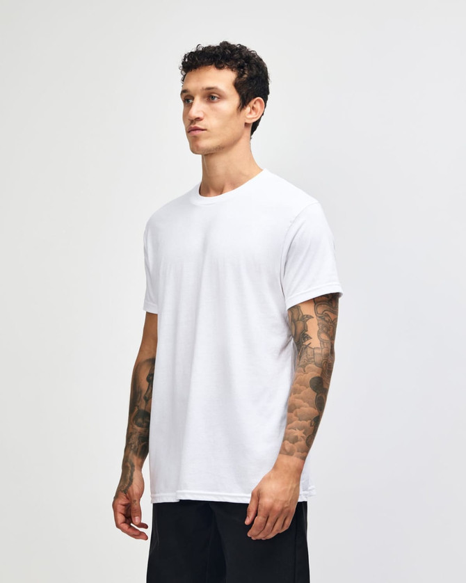 A white unisex CVC short sleeve T-shirt displayed on a model, featuring a simple design and a logo.