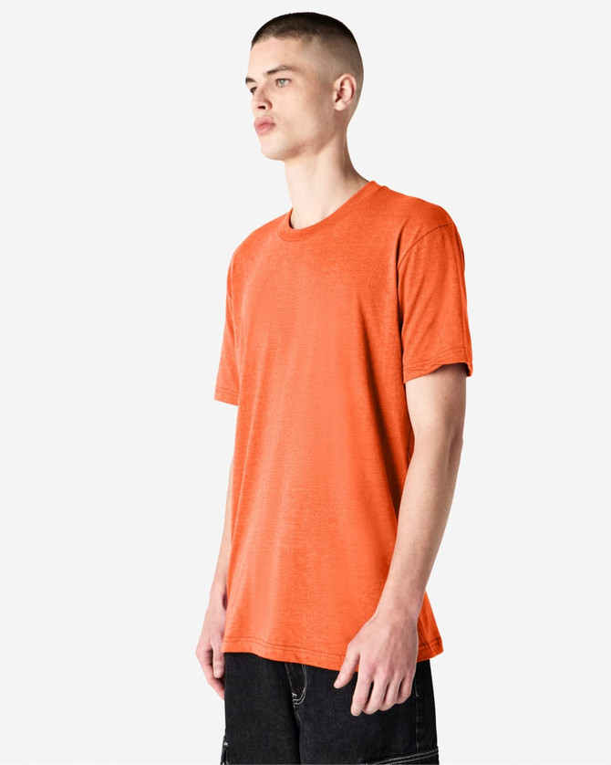 An orange unisex CVC short sleeve t-shirt displayed on a model, featuring a casual fit and a logo.