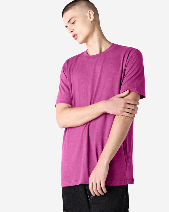 A unisex short sleeve t-shirt in a vibrant magenta colour, worn by a model with a neutral expression.