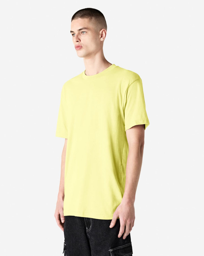 A unisex CVC short sleeve t-shirt in bright yellow, displayed on a model against a neutral background.